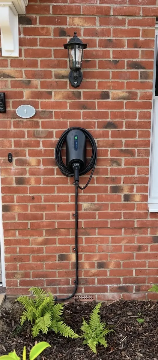Home EV charger installed on an exterior wall