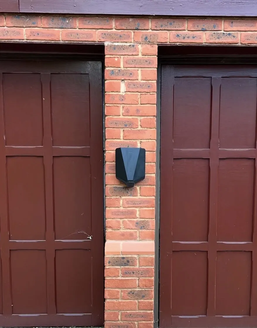 Home EV charger installed on an exterior wall