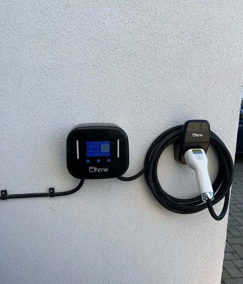 Ohme EV charger installed on a house wall