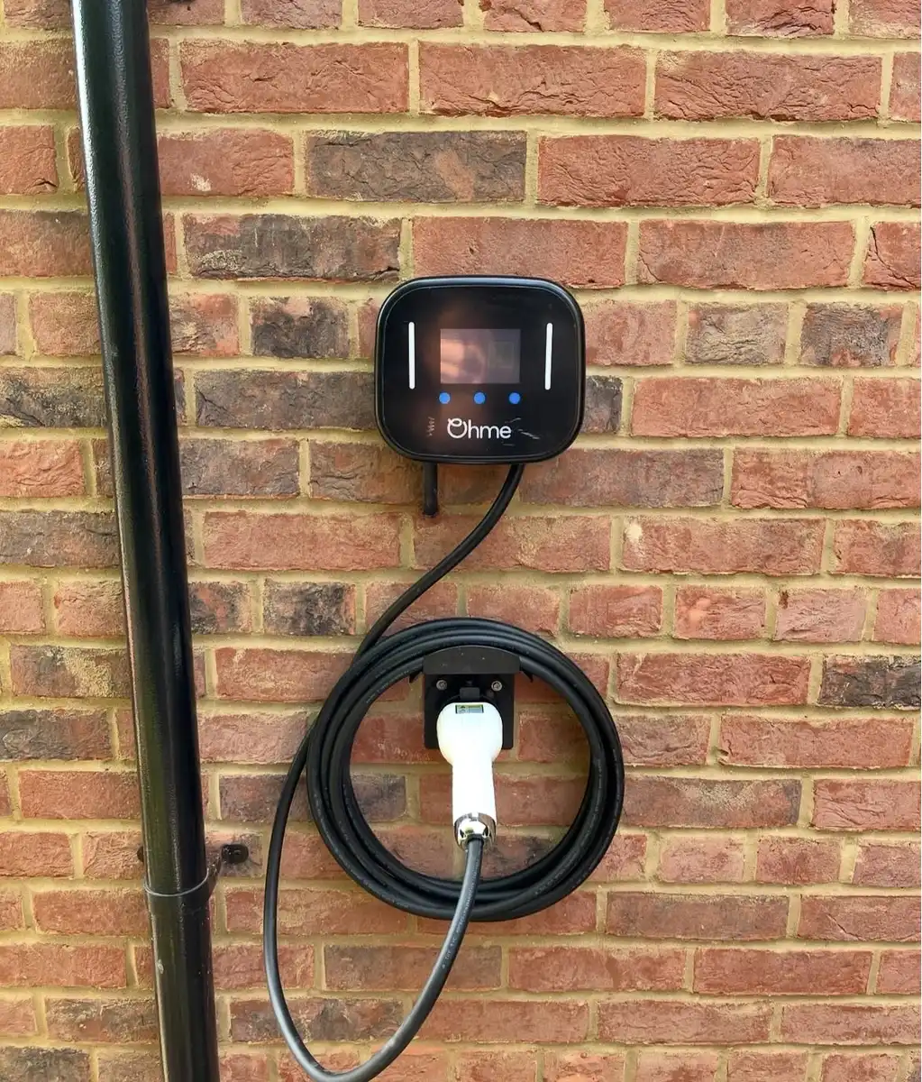 Ohme EV charger installed on a house wall